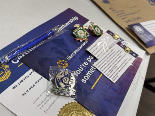 New member packet with gift of Pins 