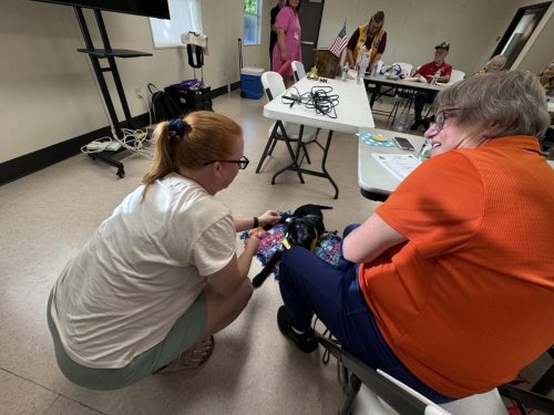 Lion Jeri with Leslie Canine Companion Pup in training getting loves from an Elk Grove Resident in attendance 